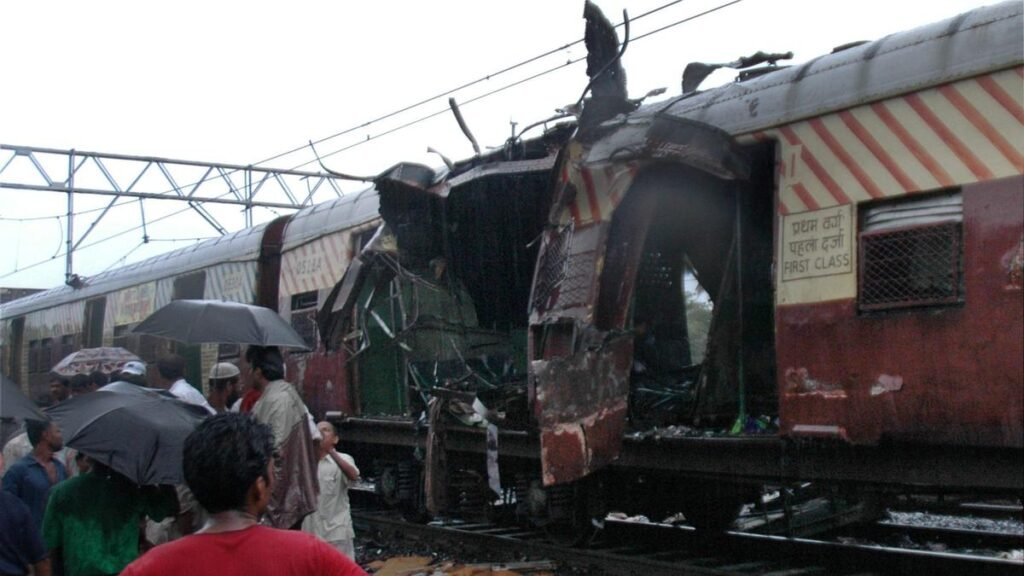 a train coach is damaged by a bomb blast at Matunga railway station in Mumbai.
